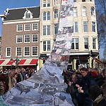 Your friends raise a ~ 20 meter banner with pictures documenting your career. The group pullies it up through electrical wires amidst much chaos which everyone enjoys.