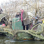 Those not on handmade rafts and boats, walk the entire distance and cheer those water-bound on at every single bridge.