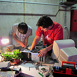 Biomodd Workshop Sint-Niklaas, 2010. Thomas and Mathias opening up a used computer at the start of the workshop.